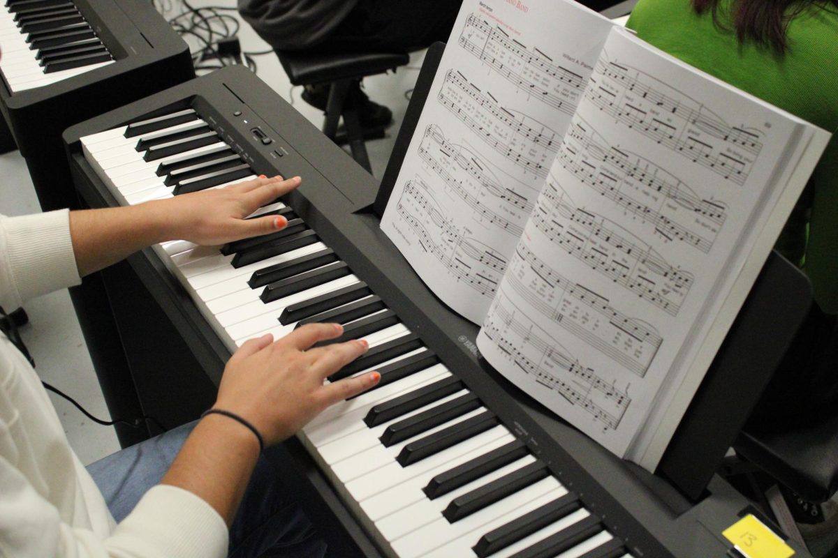 Melena Coletta listening to herself play the piano