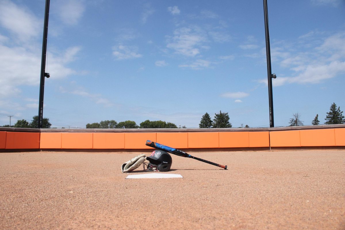 Softball pitch with a glove, helmet, and bat.